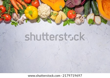 Autumn vegetables cooking background. Organic fall harvest farm vegetables, mushrooms. Various vegetarian ingredients set for cooking dinner on white kitchen background, top view copy space