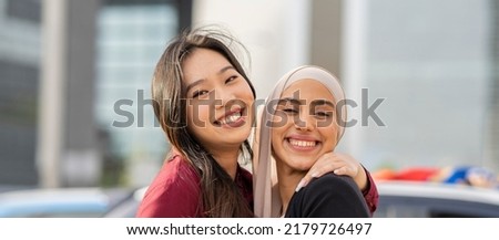 Portrait of two Asian Muslim businesswomen, Asian businesswomen or office workers, colleagues of diverse ethnic, intercultural and religious smiles accepting as colleagues in the organization.