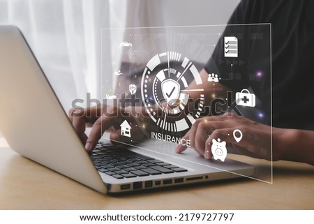 online insurance  Businessmen use computers to make insurance online.  For travel, cars, finance, health, life and family.  insurance concept Royalty-Free Stock Photo #2179727797