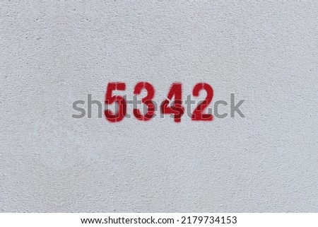 Red Number 5342 on the white wall. Spray paint.
