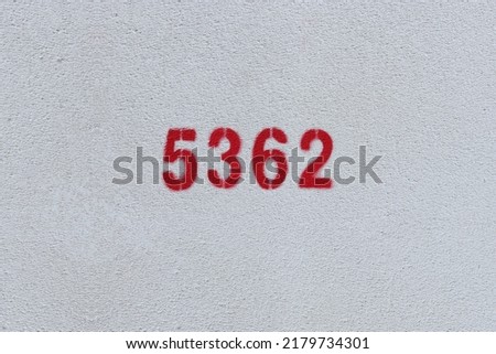 Red Number 5362 on the white wall. Spray paint.
