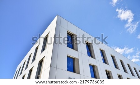 Office building with white aluminum composite panels. Facade wall made of glass and metal. Abstract modern business architecture. Royalty-Free Stock Photo #2179736035