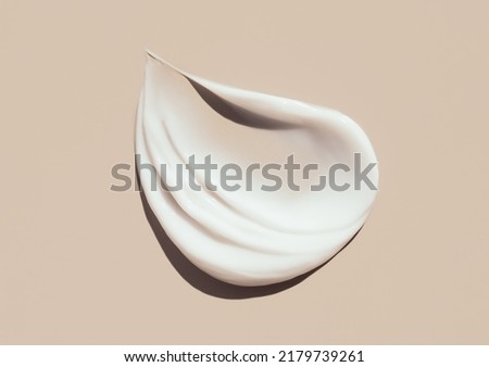 cosmetic smears of creamy texture on a pastel beige background Royalty-Free Stock Photo #2179739261