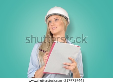 Young female engineer with a safety hardhat posing
