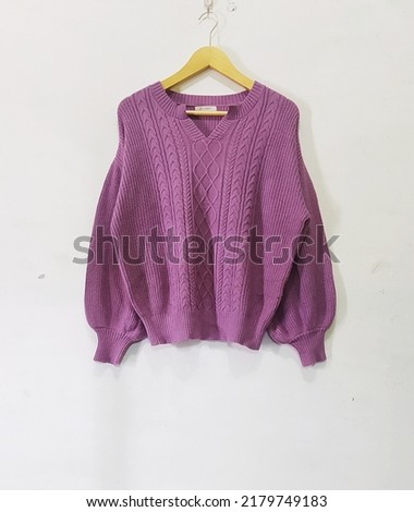 purple knit sweater with V-shaped collar, long sleeves in the shape of a balloon isolated in white background Royalty-Free Stock Photo #2179749183