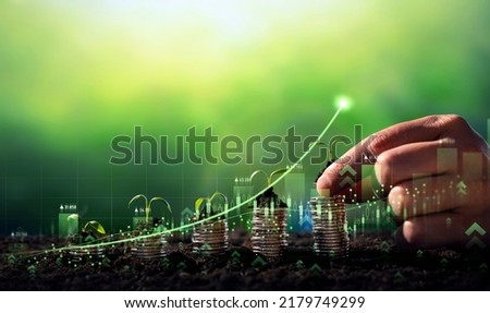 Growing money,finance and investment. Seedling are growing with business arrow of growth.Young plants on coin stacks  increase. Concept of business growth,profit, development and success.  Royalty-Free Stock Photo #2179749299