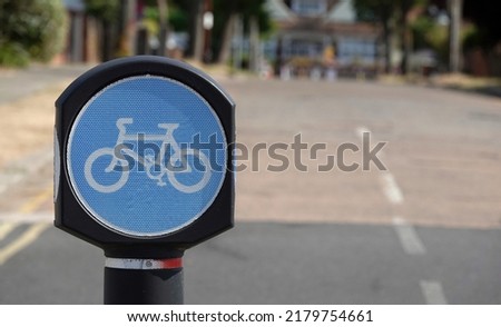 A round blue sign to mark a compulsory cycling lane along the seafront at Southend on Sea, Essex, UK.