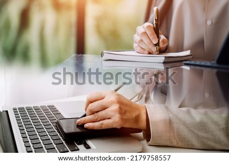 businesswoman hand working with laptop computer, tablet and smart phone in modern office with virtual icon diagram at modernoffice in morning light
