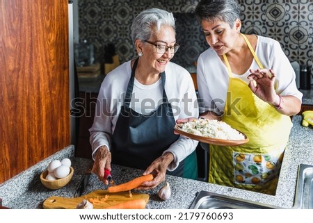 Hispanic women grandmother and daughter cooking at home kitchen in Mexico Latin America Royalty-Free Stock Photo #2179760693