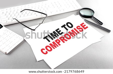 TIME TO COMPROMISE text on paper with keyboard, calculator on grey background