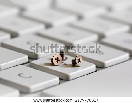Miniature fasteners on a white keyboard Royalty-Free Stock Photo #2179778317