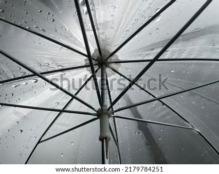 Umbrella protects from rain and under umbrella on rainy days