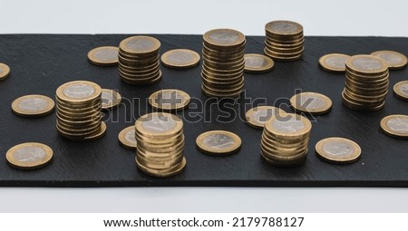 Euro coin, European currency pile.
