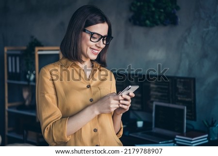 Portrait of attractive focused cheerful girl expert using device gadget developing web project at workplace workstation indoors Royalty-Free Stock Photo #2179788907