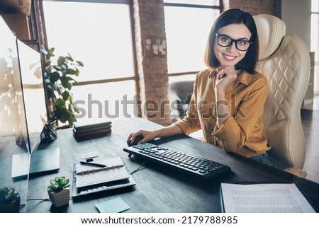 Photo of positive charming person sitting chair hand chin toothy smile create script workstation office indoors Royalty-Free Stock Photo #2179788985