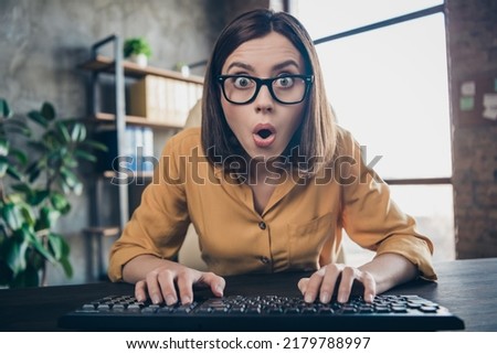 Portrait of attractive stunned girl expert typing staring reading sudden finance news development at workplace workstation indoors Royalty-Free Stock Photo #2179788997