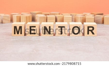 Word cubes lined up with the letters mentor written on it. Copy space available.