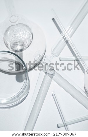 Test tubes, petri dish and glass rods in the laboratory on white background. Science research. Laboratory glassware close up. Transparent container. Medicine and beauty concept. Royalty-Free Stock Photo #2179809067