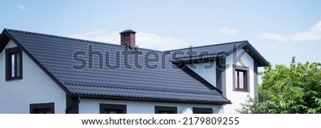 The dark-colored roof of a new residential private house Royalty-Free Stock Photo #2179809255