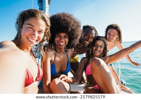 Happy multiracial friends doing tour with sailing boat - Focus on african man face