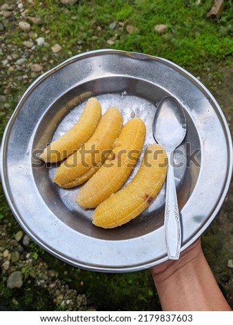 hand holding boiled split on aluminum plate, sweet and delicious