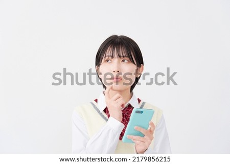 Asian high school student thinking with the smartphone in white background