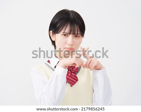 Asian high school student x sign gesture by hand in white background