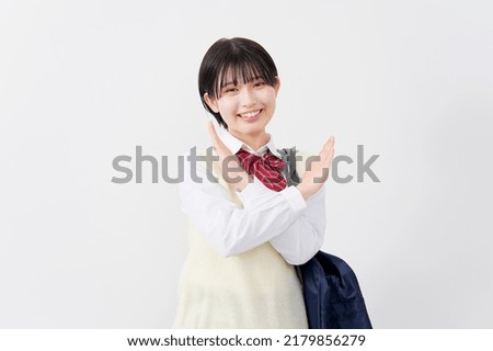 Asian high school student x sign gesture by hand in white background