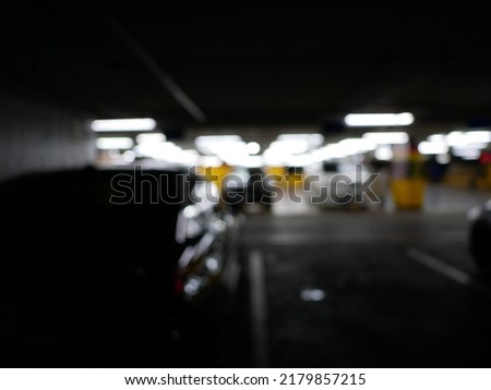 Parking car blurred. Empty road asphalt background in soft focus. Car lot parking space in underground city garage. Interior underground carpark.