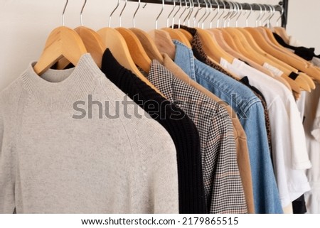 clothing hanging on wooden hangers