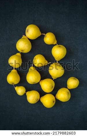 Still life with pear-shaped yellow decorative pumpkins