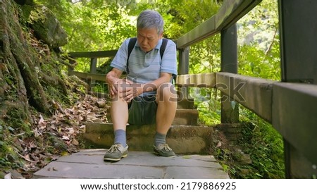 old asian man has a hurtung knee when climbing stairs Royalty-Free Stock Photo #2179886925