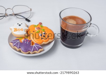 hot espresso coffee  or chocolate cup with funny Halloween Cookies. Happy Halloween day, Trick or Threat, Hello October, fall autumn, Traditional, party and holiday concept