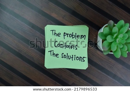 Concept of The Problem Contains The Solutions write on sticky notes isolated on Wooden Table.
