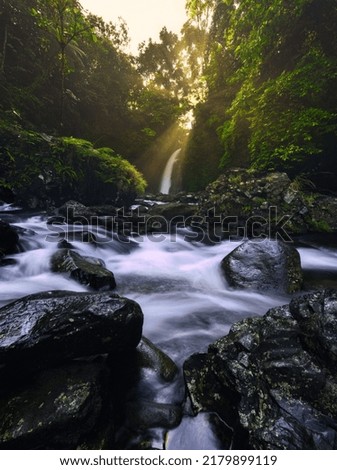 Beautiful morning view in Indonesia. Panoramic view of the waterfall with the beauty of natural sunrise light