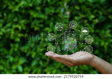 Technology, hand holding with environment Icons over the Network connection on green background