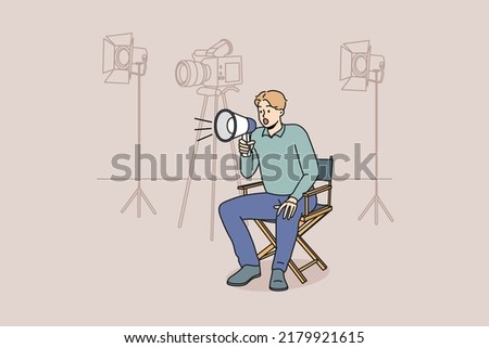 Film producer sitting on chair screaming in megaphone at shooting. Man movie director with loudspeaker manage scene. Vector illustration.  Royalty-Free Stock Photo #2179921615