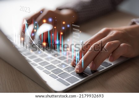woman hand using laptop on the table with virtual graph on screen