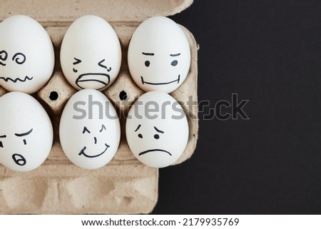 concept social networks communication and emotions - eggs on black background