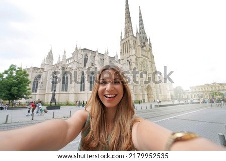 Beautiful woman takes selfie photo with Bordeaux Cathedral, France