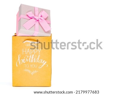 Happy Birthday bag with a birthday present against a white background