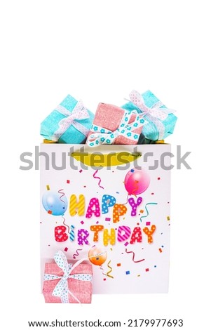 Happy Birthday bag with lots of gifts against a white background