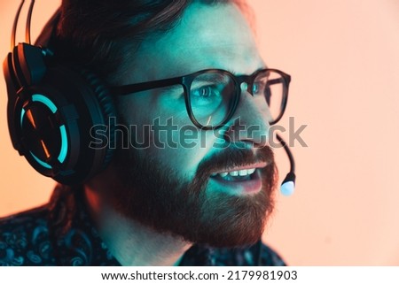 Professional bearded gamer playing the computer game on a tournament - Focused and looking closely - close up shot. High quality photo