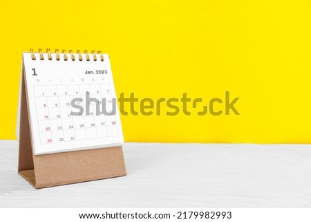 January calendar 2023 on the wooden table on a yellow background concept new year 2023 Royalty-Free Stock Photo #2179982993
