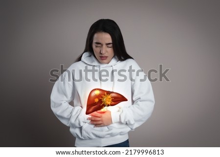 Sick woman suffering from pain and illustration of unhealthy liver on light blue background. Viral hepatitis Royalty-Free Stock Photo #2179996813