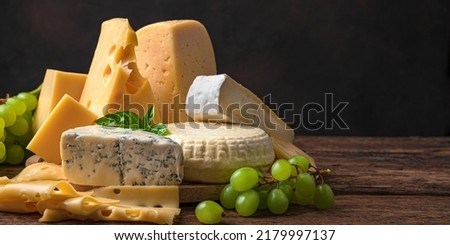 Different types of sarah on a wooden background. Assortment of cheeses. Side view. Royalty-Free Stock Photo #2179997137