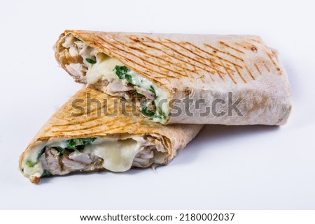 Suluguni in pita bread with chopped parsley, chicken and mushrooms on an isolated white background.