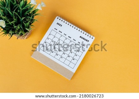 August 2023 desk calendar on yellow background. Directly above. Flat lay. Copy space. Royalty-Free Stock Photo #2180026723