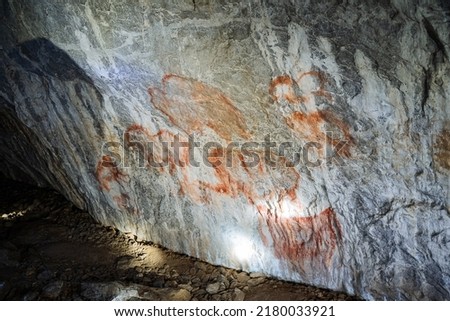 Rock paintings in the cave, ancient people painted on the walls of an underground dwelling, pictures of a caveman, a find of the century. High quality photo