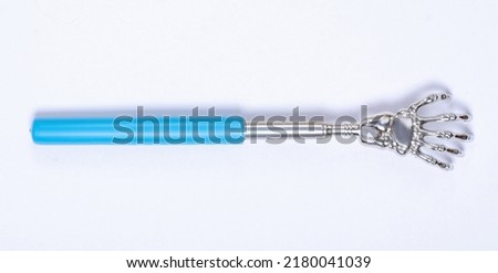 Metal back scratcher on white background isolation, top view Royalty-Free Stock Photo #2180041039